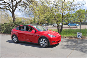 Red Tesla leaving start CP